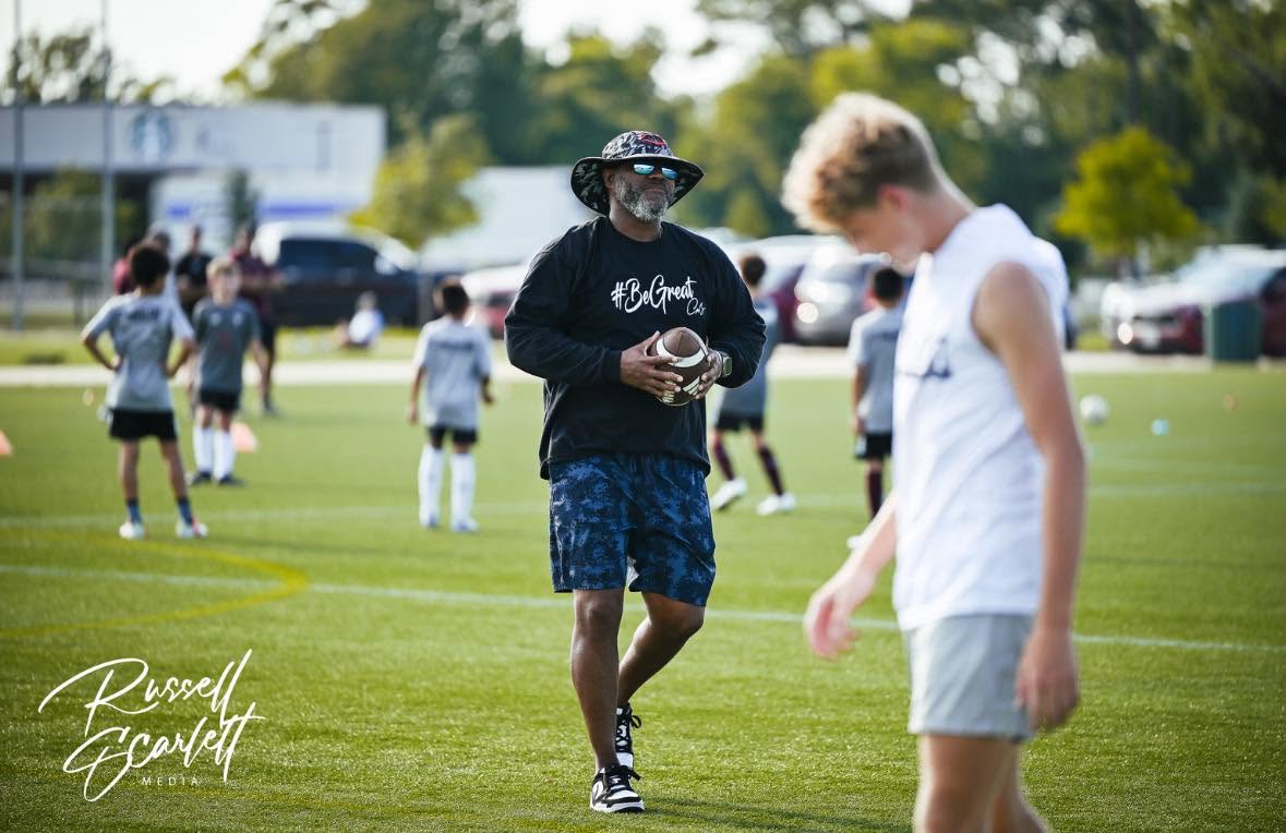 Coach Taylor training athletes on the field