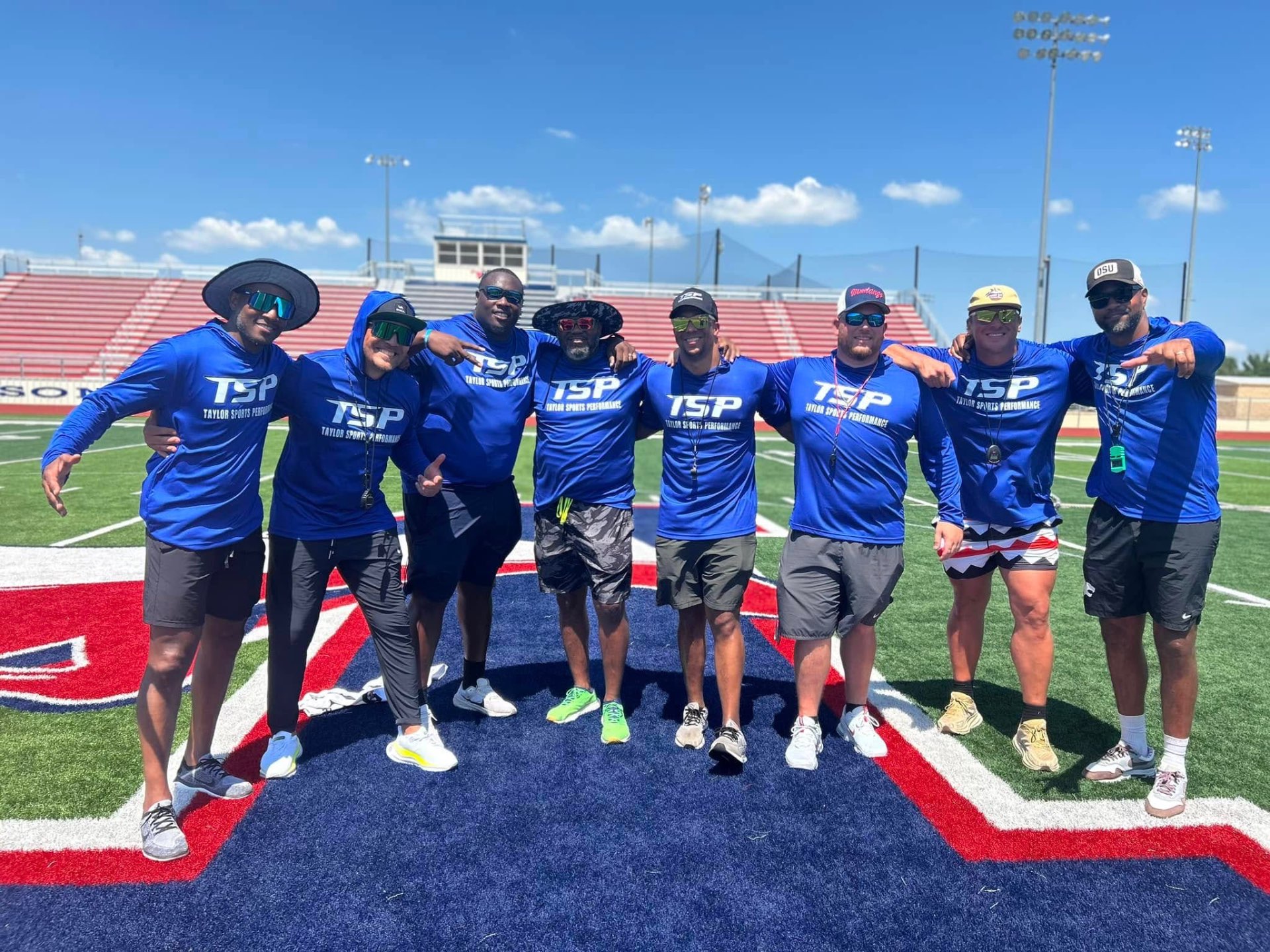 TSP coaches and staff together on the football field
